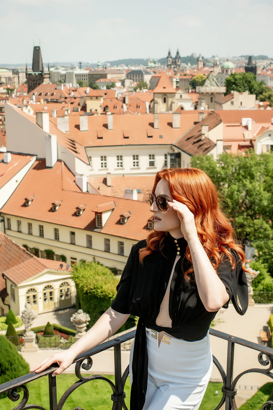 Vivien Arden u velkého okna s výhledem na město